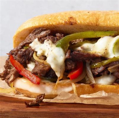  Philly Cheesesteak:  A Symphony of Savory Sizzling Steak and Melty Gooey Cheese!